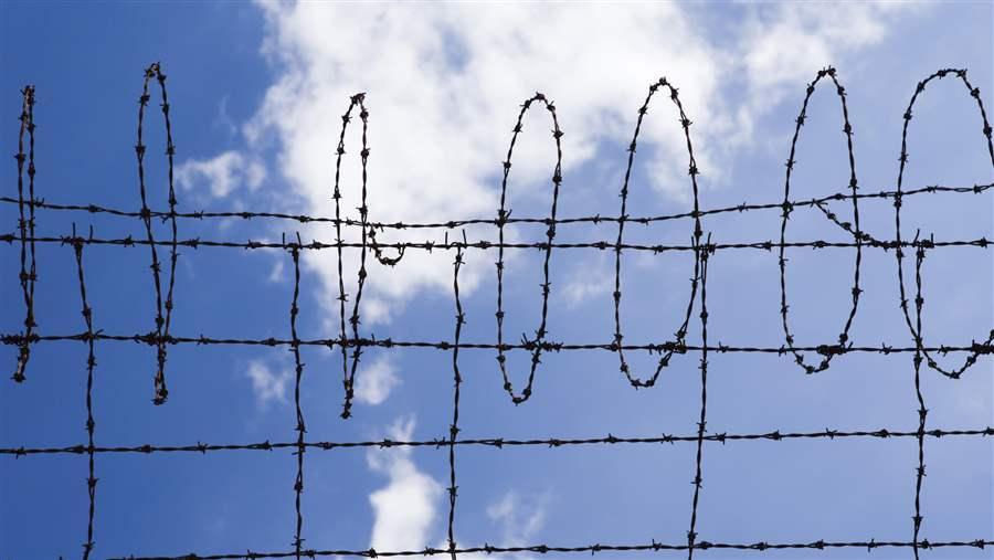 Barbed wire against blue sky